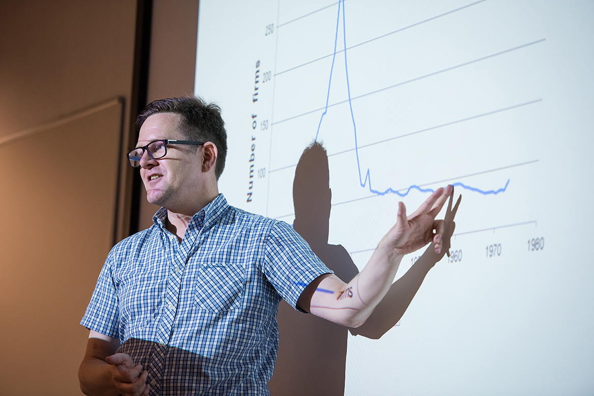 Lecturer pointing at a graph
