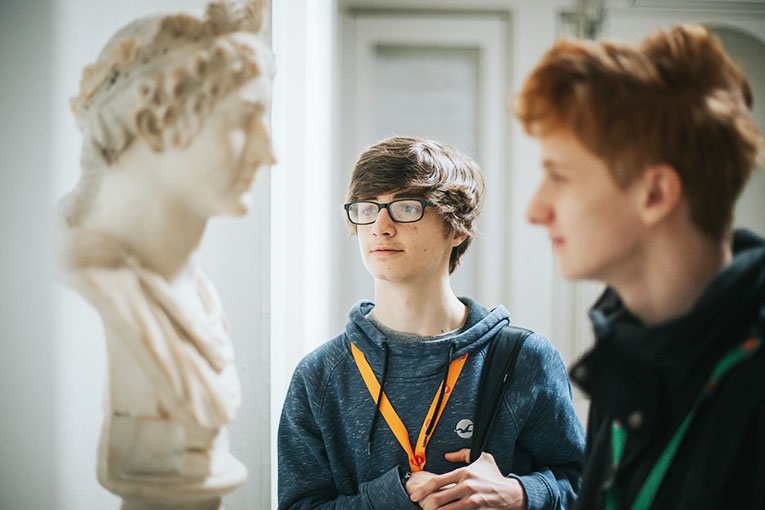 Two students looking at a statue