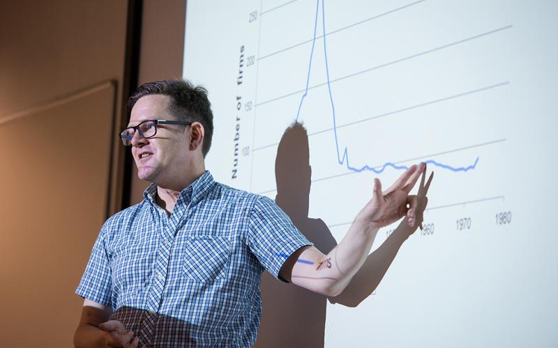 Lecturer pointing at a graph