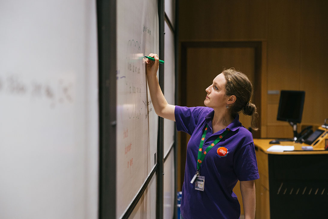 Teacher writing on a board