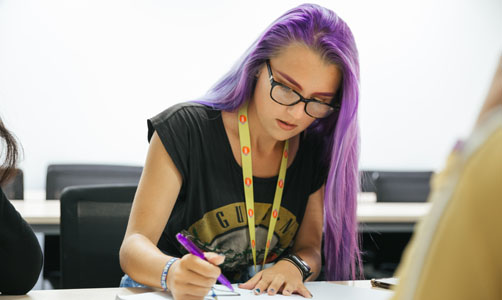 Student writing in class