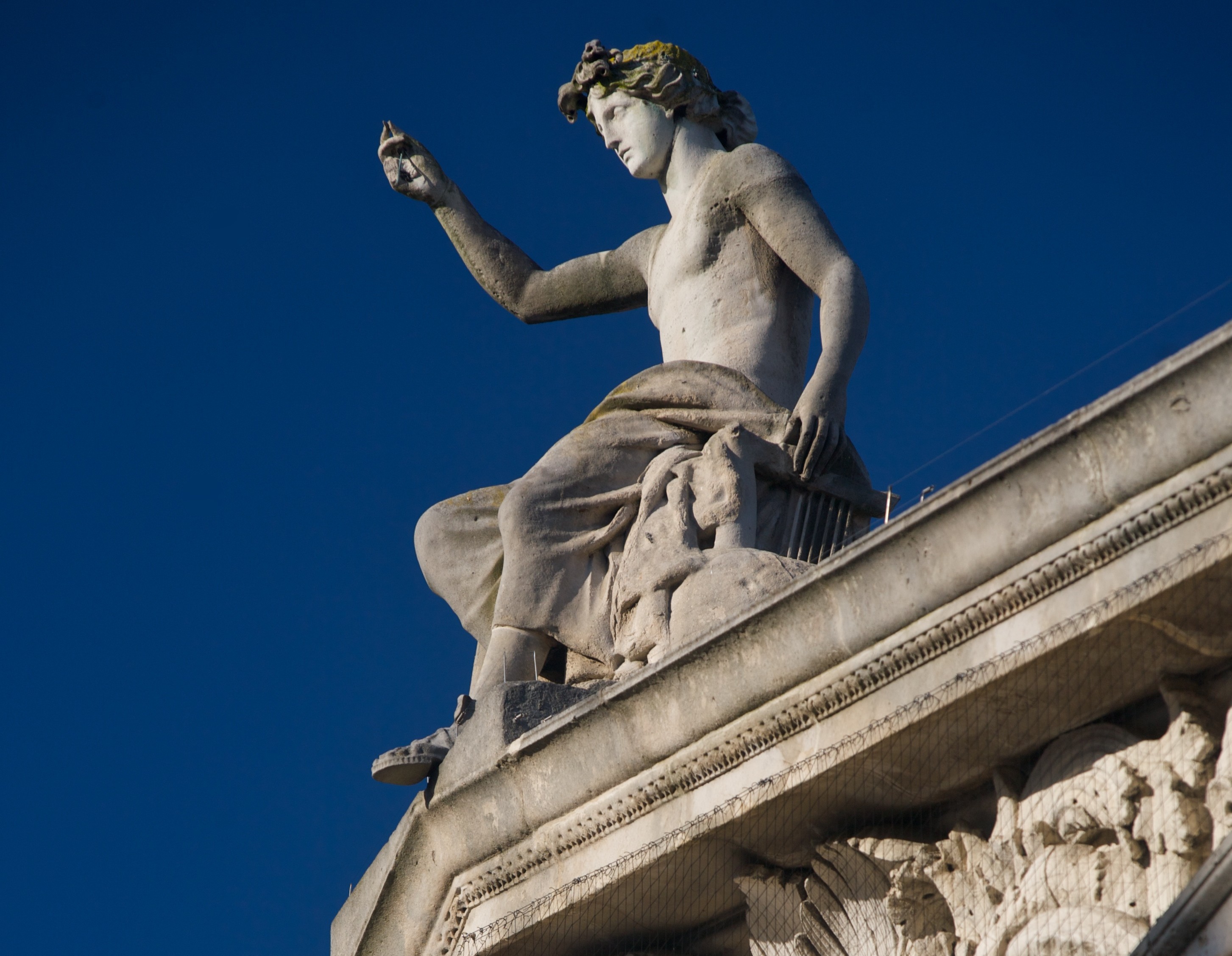 Apollo statue on top of building