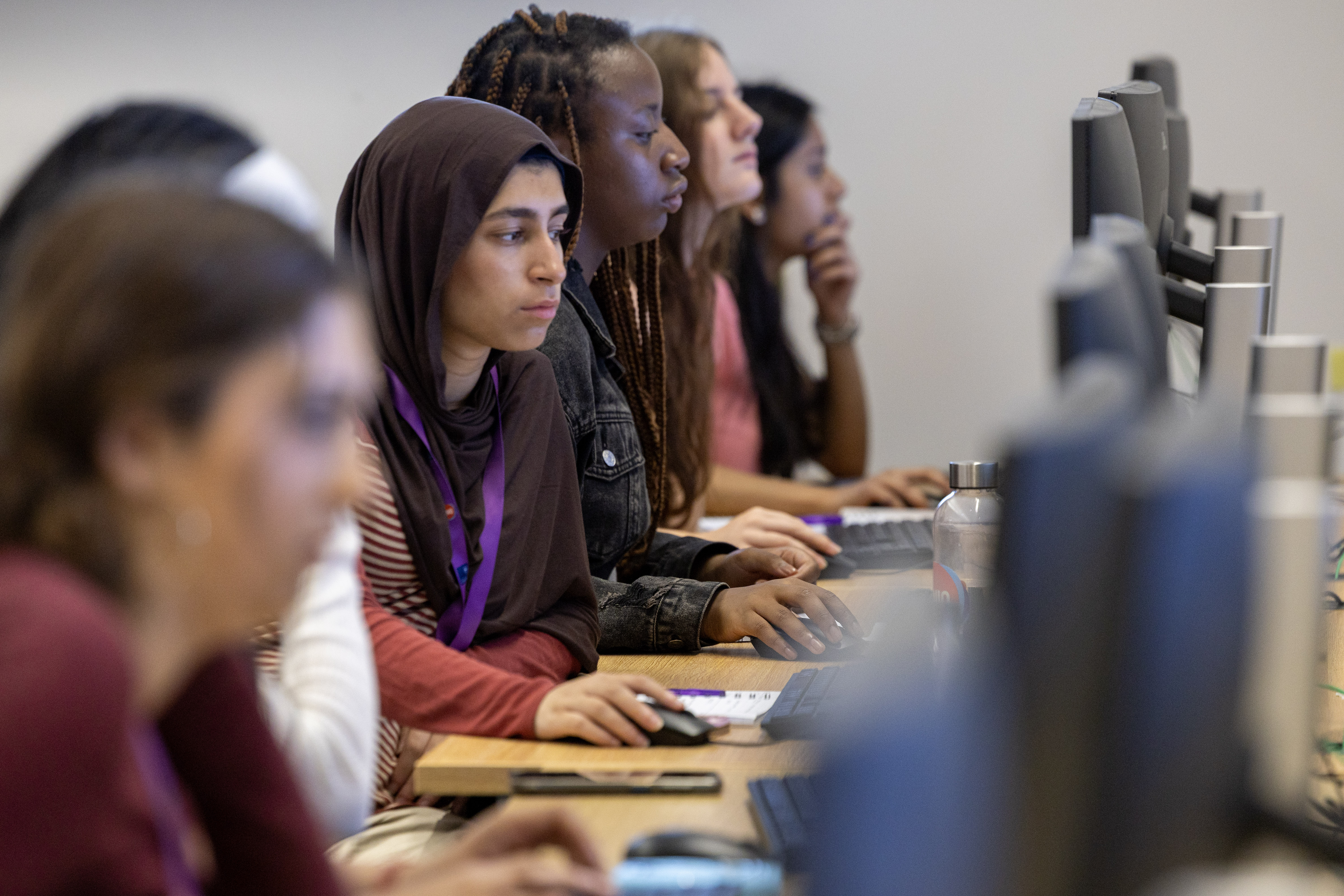 Row of students sat at computers