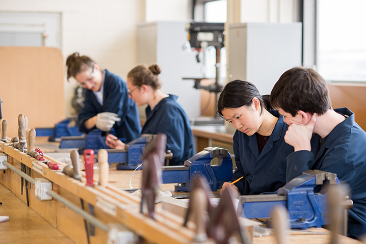 Four students in a class looking at work