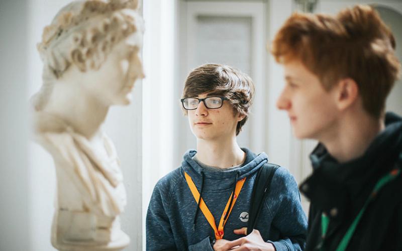 Two students looking at a statue