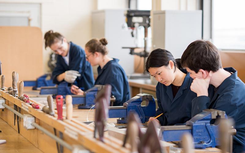 Four students in a class looking at work