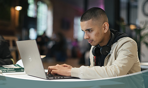 Student writing in class